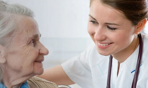 LPN to BSN Student Smiling with Elderly Patient