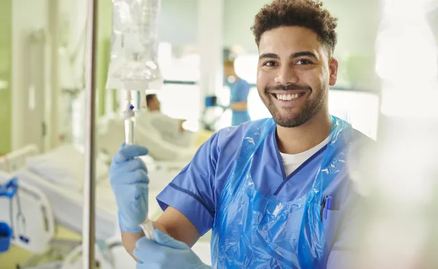 young male nurse adjusting iv drip