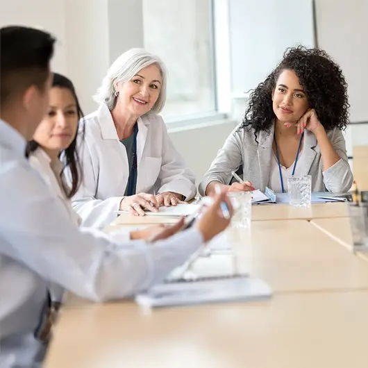 Healthcare administrator meeting with staff