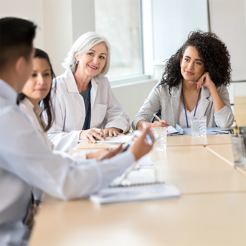 Healthcare administrator meeting with staff