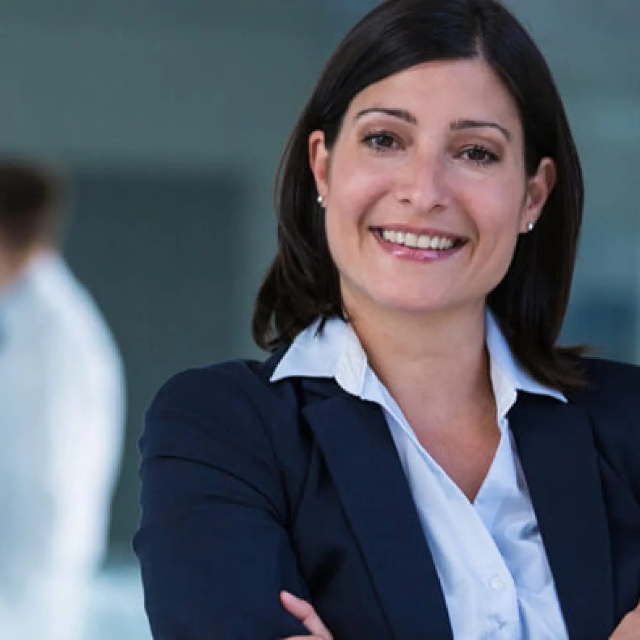 Nurse Leader with Healthcare Administrators in Meeting in Background 