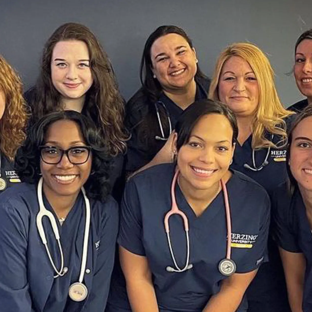 Group of Nursing Students in Scrubs Smiling