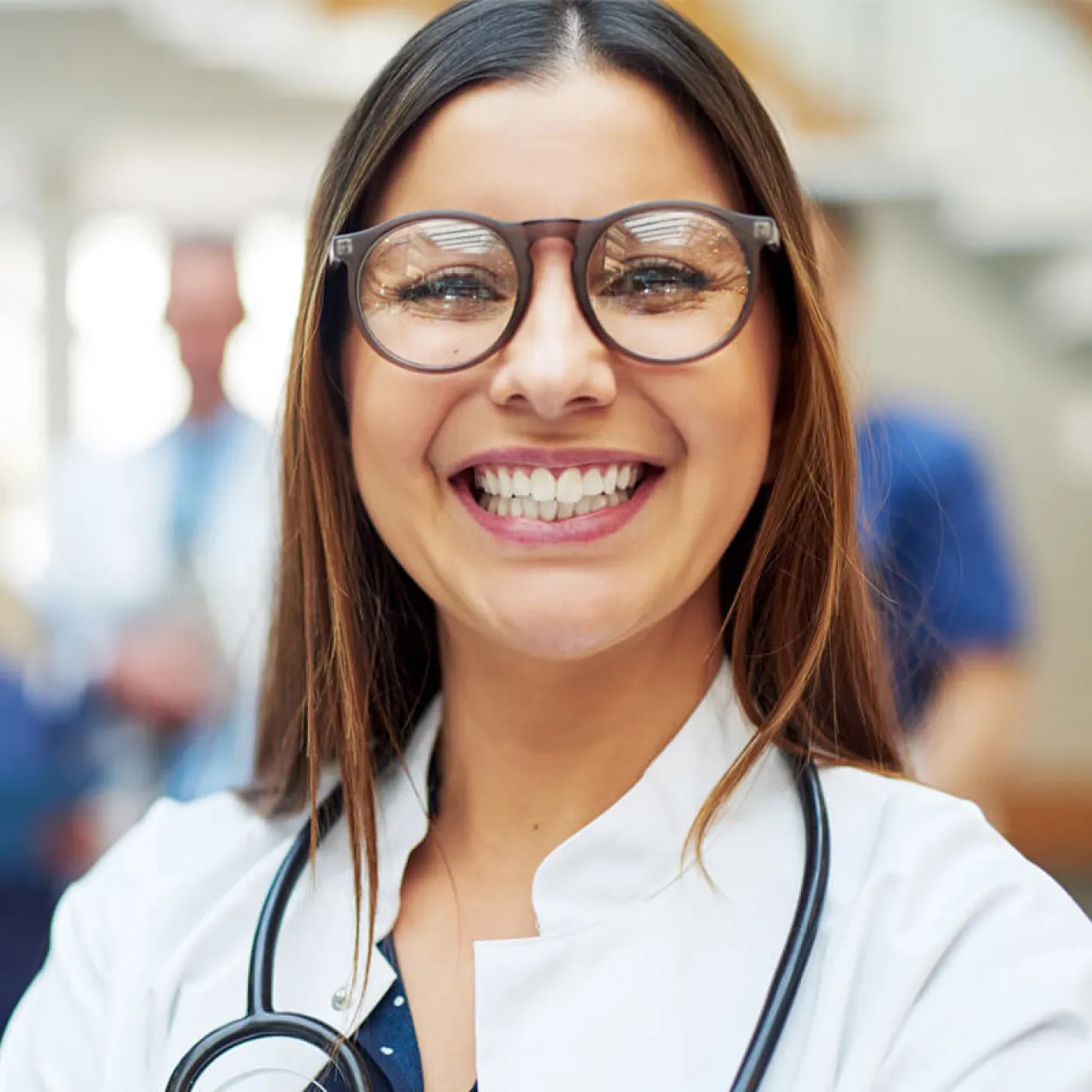 Family nurse practitioner with DNP smiling with team of medical professionals