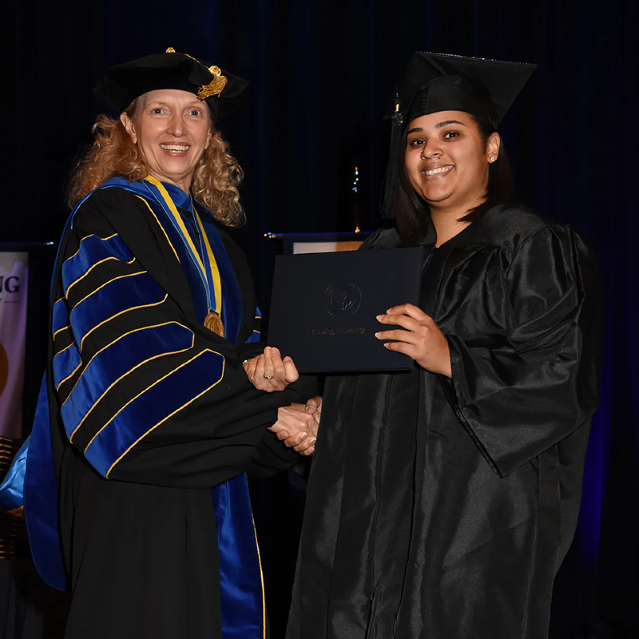 Herzing University graduate receives her diploma