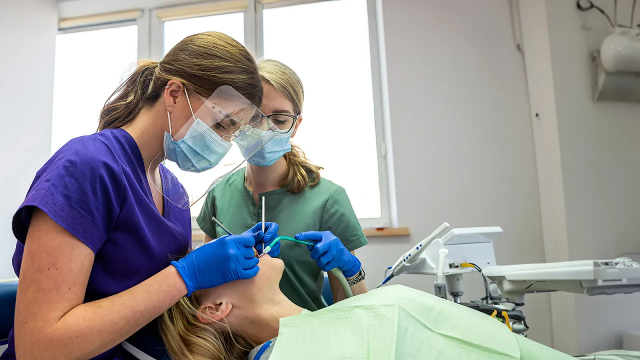 Dental students cleanint teeth