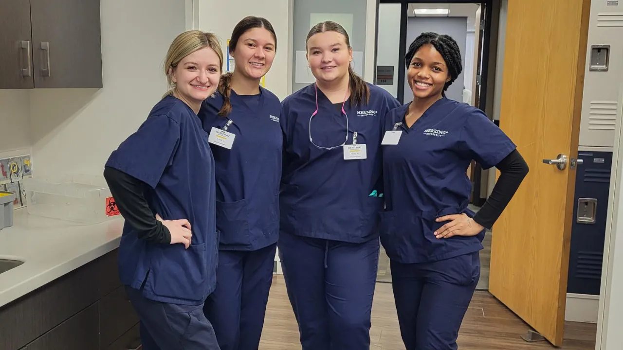 Herzing Dental Assisting students with instructor