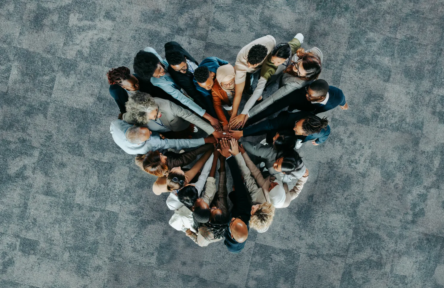 A diverse business group standing in a heart formation, symbolizing unity, teamwork, and collaboration.