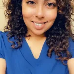 Woman in scrubs poses for a selfie