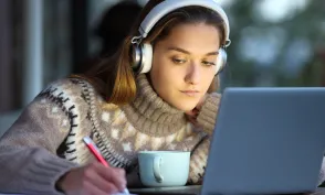 Student e-learning in a coffee shop in winter