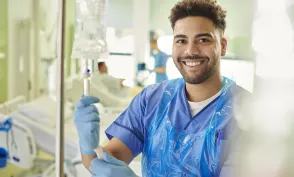 young male nurse adjusting iv drip