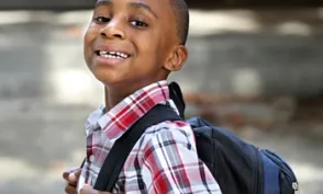 Child carrying new backpack