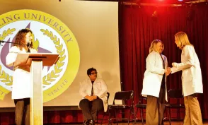 Herzing University Minneapolis white coat ceremony on stage