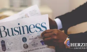 Man wearing watch reading newspaper