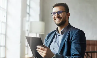 Business analyst from Georgia who graduated with MBA smiling in business meeting