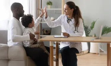 Family Nurse Practitioner FNP High Fiving Child Patient