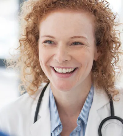 Public health nurse smiling in hospital with RN