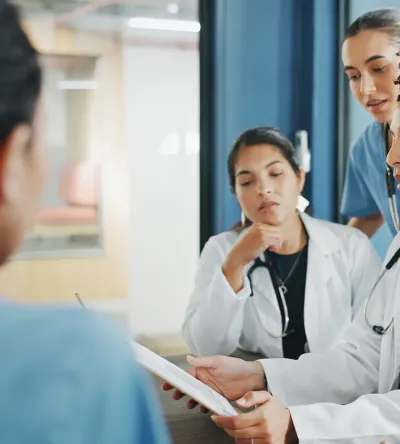 Nurse executive with DNP and medical team in background