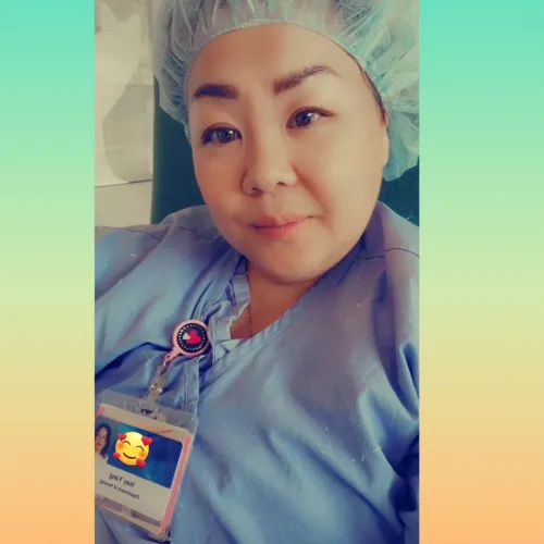 Woman poses for a selfie in full scrubs and cap