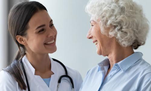 Nurse Practitioner Smiling with Adult Geriatric Patient