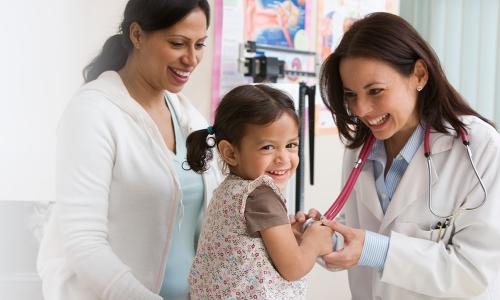 Nurse Practitioner Smiling Holding Laughing Infant 