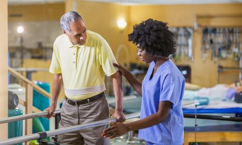 Orlando physical therapist assistant helping elderly patient regain balance