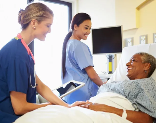 CVICU Cardiac Nurse Speaking with Patient in Hospital Bed