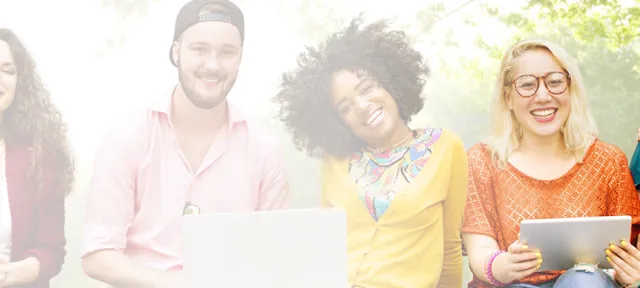 Group of diverse college students smiling with laptops