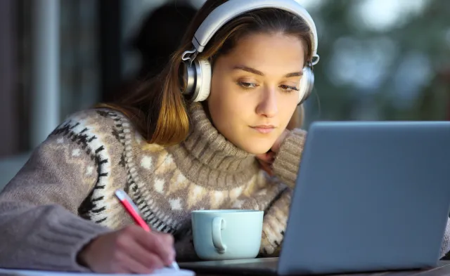 Student e-learning in a coffee shop in winter