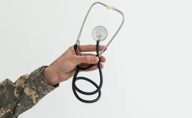 Young man army soldier holding stethoscope