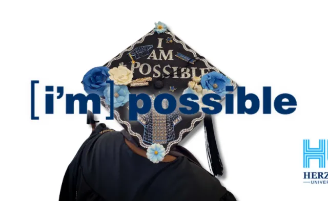I'm Possible grad cap with Herzing University logo