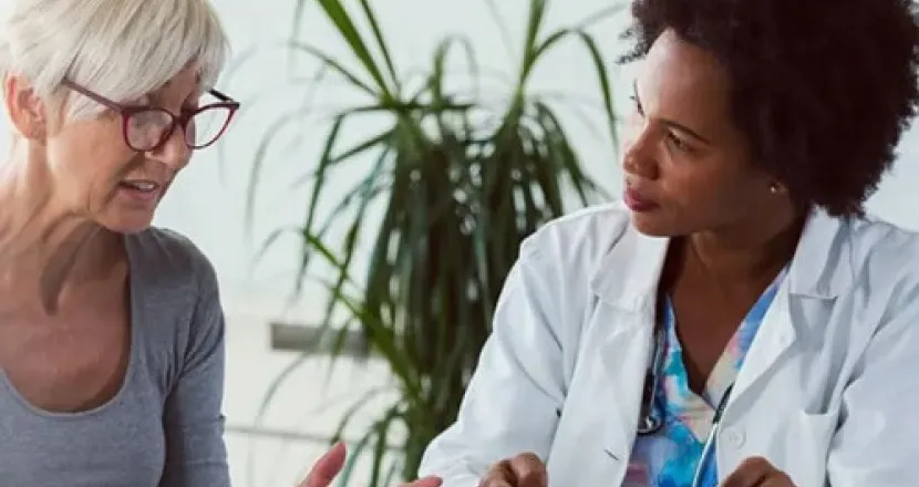 Primary Care Nurse Practitioner Consulting with Adult Female Patient