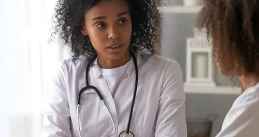 Family Nurse Practitioner Speaking with Adult Female Patient
