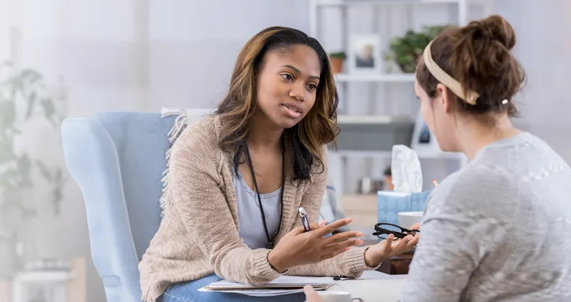 Substance Abuse Counselor with Psychology Degree Smiling with Client