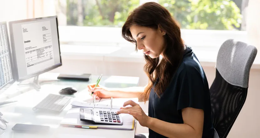 Accountant Seated at Desk Calculating Balances