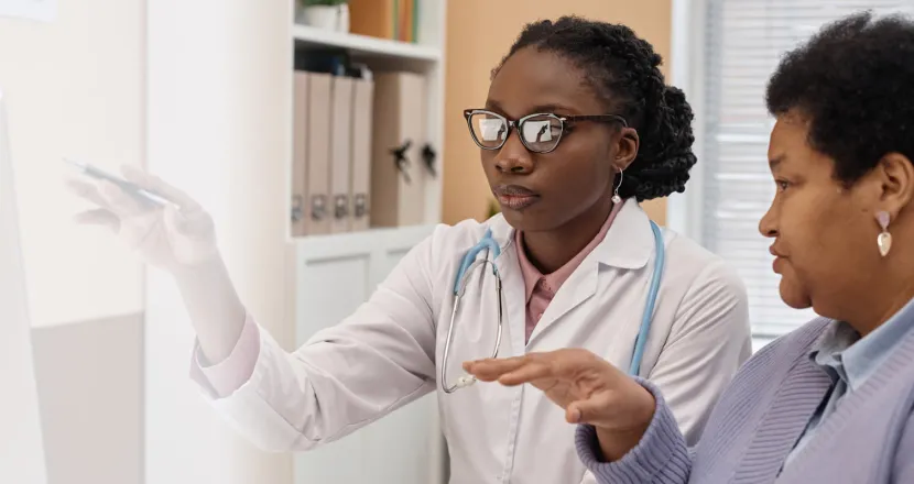 DNP AGPCNP Badge Banner Primary care nurse practitioner with DNP consulting with patient