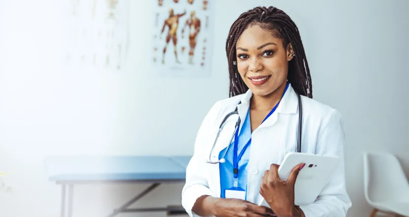 Women's health nurse practitioner with DNP smiling in clinic