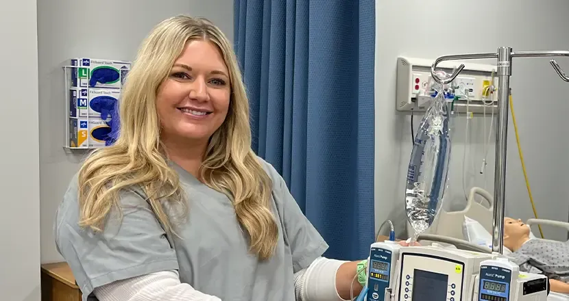 Smiling nurse with IV pump 