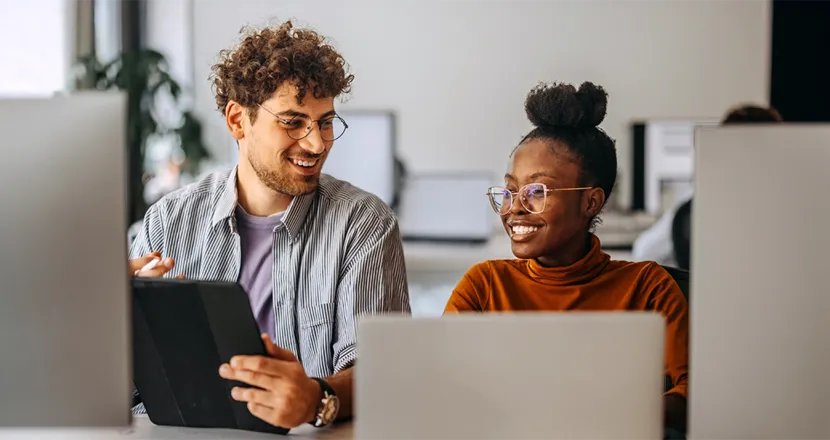 IT students working together in a computer lab, showcasing teamwork and hands-on learning in the Information Technology program.