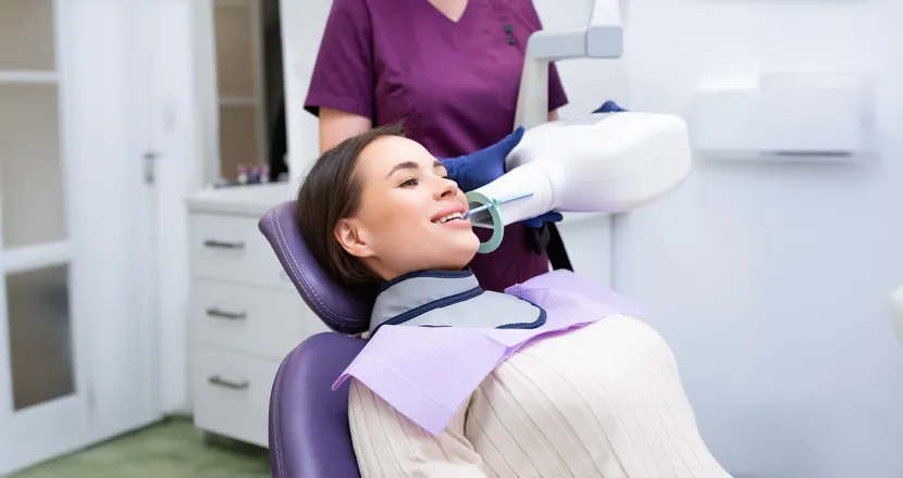 A dental professional using advanced radiology equipment to capture a dental X-ray, representing hands-on training in Herzing University’s dental radiology certificate program.