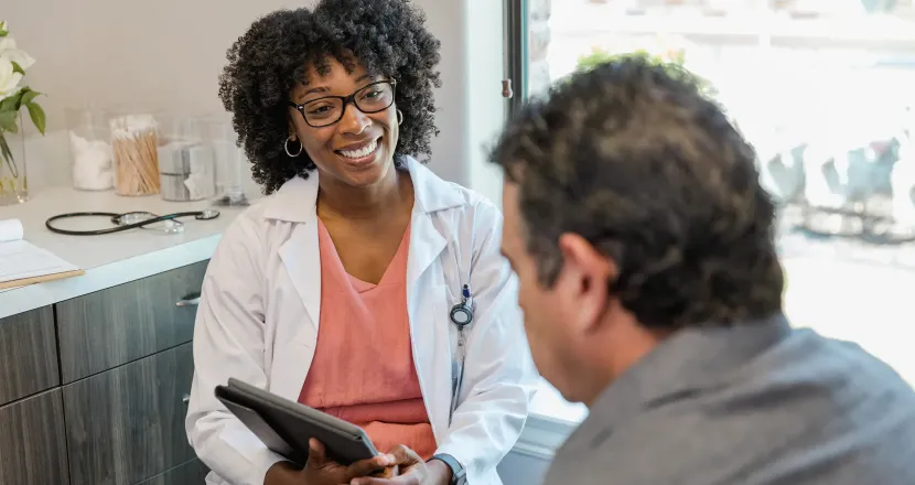 Family nurse practitioner with DNP smiling with team of medical professionals