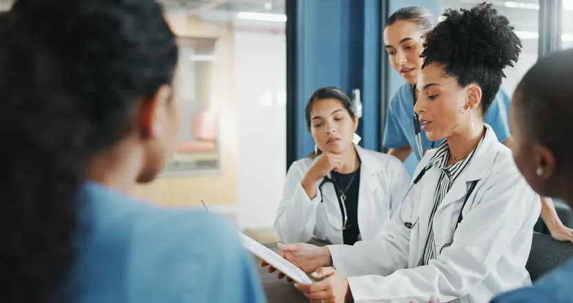 Nurse executive with DNP and medical team in background