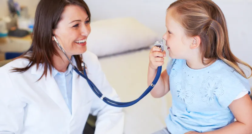 Pediatric Nurse Practitioner Smiling with Young Patient