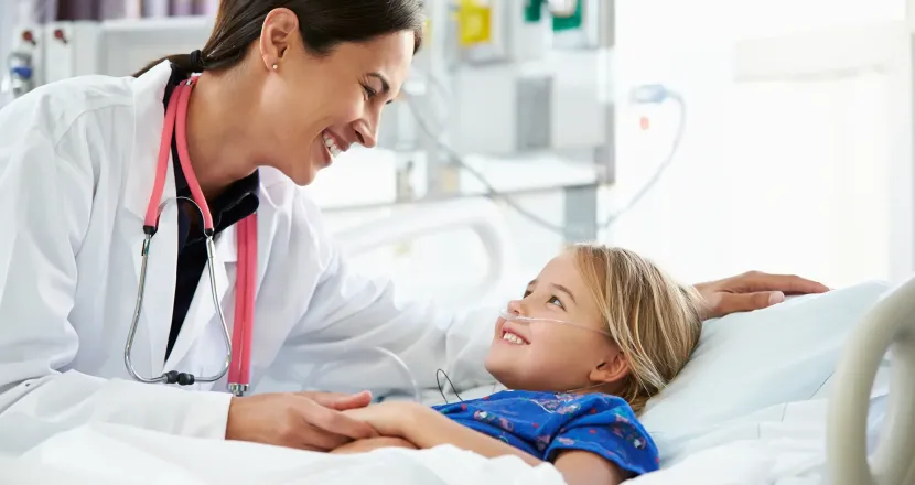 Pediatric nurse practitioner with DNP working with young patient