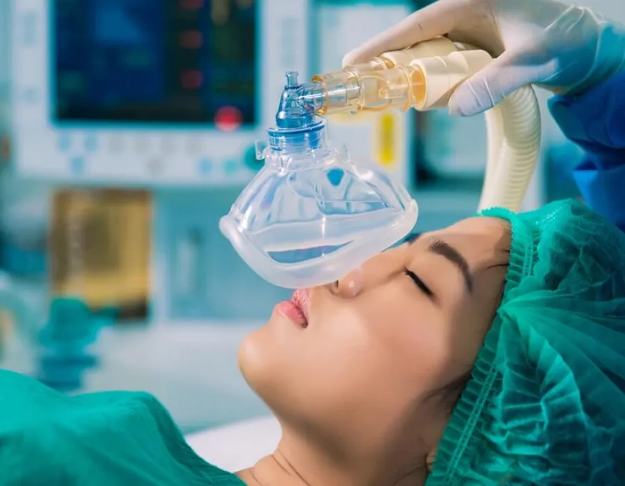 Patient laying on hospital bed about to be put under by a nurse anesthetist