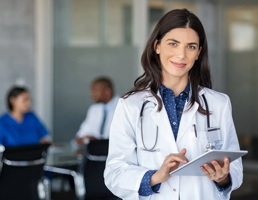 Nurse practitioner smiling in office after meeting with hospital administrators