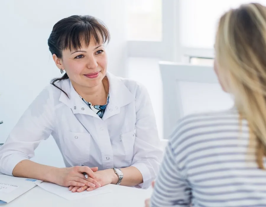 Adult Gerontology nurse practitioner smiling during appointment with patient