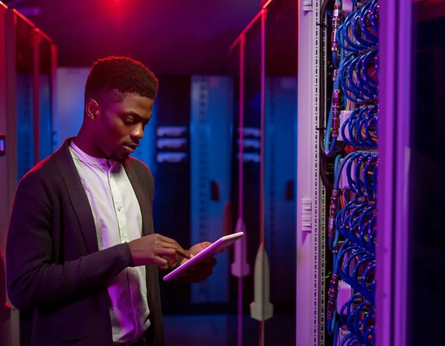 Cyber Security Analyst Using Tablet in Server Room