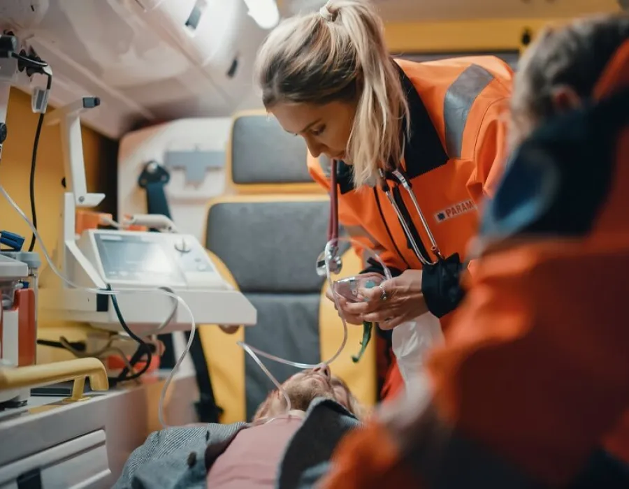 Emergency Medical Technician EMT Treating Patient in Ambulance