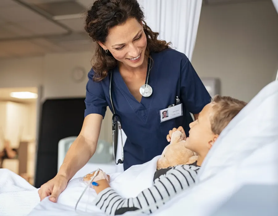 Nurse Smiling with Pediatric Patient in Hospital