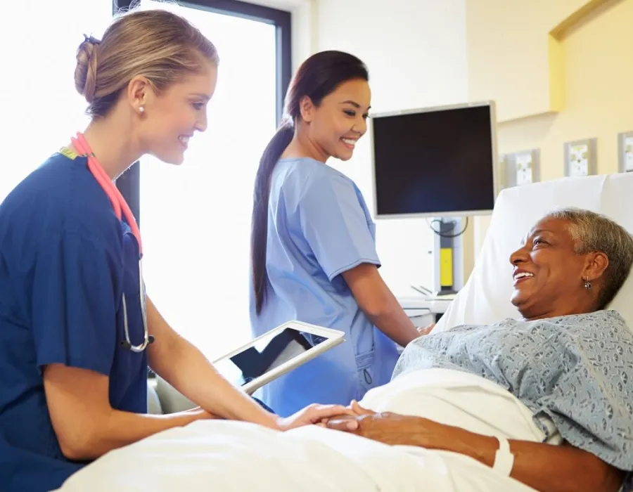 CVICU Cardiac Nurse Speaking with Patient in Hospital Bed